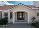 Front door entryway with a dark brown door and brick pathway at 2813 Sancho Panza Ct, Punta Gorda, FL 33950