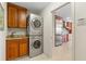 Laundry room with stackable washer and dryer, and kitchen view at 2813 Sancho Panza Ct, Punta Gorda, FL 33950