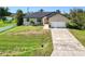 House with a yard, driveway, and white fence at 3021 Palm Dr, Punta Gorda, FL 33950
