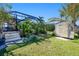 Spacious backyard with screened enclosure, shed, and lush tropical landscaping at 3021 Palm Dr, Punta Gorda, FL 33950