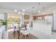 Dining area with a wood table and white chairs, next to kitchen at 3021 Palm Dr, Punta Gorda, FL 33950
