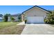 Tan house with white garage door and landscaping at 3021 Palm Dr, Punta Gorda, FL 33950