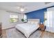 Spacious main bedroom with a blue accent wall and plenty of natural light at 3021 Palm Dr, Punta Gorda, FL 33950