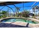 Kidney shaped pool with a screened enclosure at 3021 Palm Dr, Punta Gorda, FL 33950