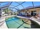 Relaxing pool area with covered patio and comfortable seating at 3021 Palm Dr, Punta Gorda, FL 33950