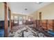 Damage living room with exposed walls and damaged flooring at 303 Gill St, Punta Gorda, FL 33950