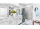 Bathroom boasts a double vanity, shower, and modern decor at 5131 Schubert Trl, North Port, FL 34287