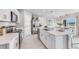 Open concept kitchen boasting white cabinets, a large island, and stainless steel appliances at 5131 Schubert Trl, North Port, FL 34287