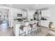 Bright kitchen featuring white cabinets, an island, and stainless steel appliances at 5131 Schubert Trl, North Port, FL 34287