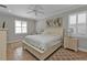 Bright bedroom with king-size bed and window with plantation shutters at 8533 Peregrine Way, North Port, FL 34287