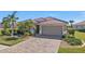 Single-story home with tile roof and landscaped yard at 8533 Peregrine Way, North Port, FL 34287