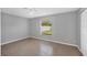 Well-lit bedroom featuring tile flooring and a window at 12352 Birtle Ave, Port Charlotte, FL 33981