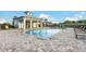 Community pool with a covered patio and lounge chairs at 14025 Black Beauty Dr # 412, Punta Gorda, FL 33955