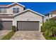 Two-car garage and front entrance of townhome at 14025 Black Beauty Dr # 412, Punta Gorda, FL 33955