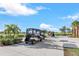 Golf carts parked in a sunny community lot at 14025 Black Beauty Dr # 412, Punta Gorda, FL 33955
