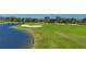 Golf course with lakefront views, players visible at 14025 Black Beauty Dr # 412, Punta Gorda, FL 33955