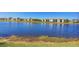 Serene lake view with community buildings in background at 14025 Black Beauty Dr # 412, Punta Gorda, FL 33955