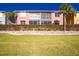 Two story building with pink exterior and landscaped grounds at 2002 Bal Harbor Boulevard # 811, Punta Gorda, FL 33950