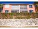 Two story building with pink exterior and landscaped grounds at 2002 Bal Harbor Boulevard # 811, Punta Gorda, FL 33950