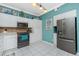 Bright kitchen with white cabinets, stainless steel appliances, and tile backsplash at 2002 Bal Harbor Boulevard # 811, Punta Gorda, FL 33950