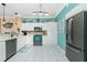 Modern kitchen featuring white cabinets, stainless steel appliances, and a teal accent wall at 2002 Bal Harbor Boulevard # 811, Punta Gorda, FL 33950