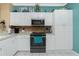 White kitchen features stainless steel appliances and mosaic tile backsplash at 2002 Bal Harbor Boulevard # 811, Punta Gorda, FL 33950