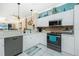 White kitchen cabinets, stainless steel appliances and a view into the living room at 2002 Bal Harbor Boulevard # 811, Punta Gorda, FL 33950