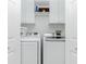 Bright laundry room with washer and dryer, and white cabinets at 2002 Bal Harbor Boulevard # 811, Punta Gorda, FL 33950