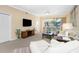Living room features comfortable seating, a large TV, and patio access at 2002 Bal Harbor Boulevard # 811, Punta Gorda, FL 33950