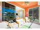 Spacious screened porch with wicker furniture and view of living room at 2002 Bal Harbor Boulevard # 811, Punta Gorda, FL 33950