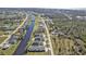 Aerial view showing a group of houses near the water, with roads and other houses visible in the background at 222 Boundary Blvd # 222P, Rotonda West, FL 33947