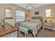 Bedroom with coastal-themed bedding, a dresser, and wood flooring at 222 Boundary Blvd # 222P, Rotonda West, FL 33947