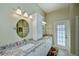 Elegant bathroom with double vanity, granite countertops, and a large mirror at 23177 Mcmullen Ave, Port Charlotte, FL 33980