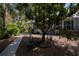 Landscaped front yard with a bench and mature trees at 23177 Mcmullen Ave, Port Charlotte, FL 33980