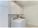 Bright laundry room with washer, dryer and overhead cabinets at 2436 Rosa Ln, Punta Gorda, FL 33950