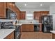 Modern kitchen with dark wood cabinets and stainless steel appliances at 24368 Westgate Blvd, Punta Gorda, FL 33980