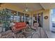 Relaxing sunroom with wicker furniture and view of the pool and kitchen at 24368 Westgate Blvd, Punta Gorda, FL 33980