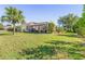 Expansive backyard with lush grass and a screened patio area at 25475 Terrain Ln, Punta Gorda, FL 33983