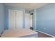 Light blue bedroom with carpet, double closet and door to hallway at 268 Maraca St, Punta Gorda, FL 33983