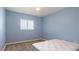 Light blue bedroom with carpet, double closet and window at 268 Maraca St, Punta Gorda, FL 33983