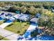 Aerial view of home with mature landscaping, solar panels and detached garage at 28427 Sabal Palm Dr, Punta Gorda, FL 33982