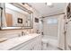 Bright bathroom features marble countertops, a large mirror, and a shower-tub combination at 28427 Sabal Palm Dr, Punta Gorda, FL 33982