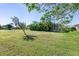 Large backyard with lush landscaping and mature trees at 3014 Guadalupe Dr, Punta Gorda, FL 33950