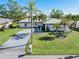 Single-story home with metal roof, palm trees, and landscaped yard at 3014 Guadalupe Dr, Punta Gorda, FL 33950