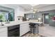 Kitchen with white cabinets, black appliances, and a breakfast bar at 3014 Guadalupe Dr, Punta Gorda, FL 33950