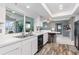 Kitchen with stainless steel sink, white cabinets and view to backyard at 3014 Guadalupe Dr, Punta Gorda, FL 33950