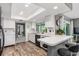 L-shaped kitchen with white cabinets, black appliances, and wood-look flooring at 3014 Guadalupe Dr, Punta Gorda, FL 33950