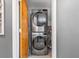 Modern laundry room with stacked washer and dryer at 3014 Guadalupe Dr, Punta Gorda, FL 33950