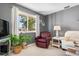 Living room with a leather armchair and large window at 3014 Guadalupe Dr, Punta Gorda, FL 33950