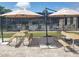 Community pool area with picnic tables and umbrellas at 4022 Beaver Ln # 800D, Port Charlotte, FL 33952